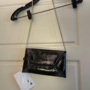 Sleek Black Snakeskin Clutch by Stuart Weitzman